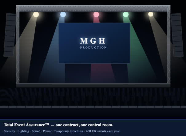 An MGH-rigged stage: overhead truss, moving heads, flown line arrays and a pit barrier in front of a lit crowd.